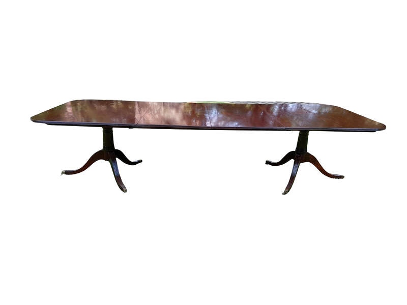 A 20th Century Regency-style Mahogany Extending Dining Table On Casters with Two Leaves and One O...