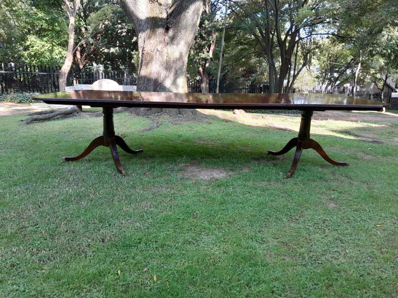 A 20th Century Regency-style Mahogany Extending Dining Table On Casters with Two Leaves and One O...