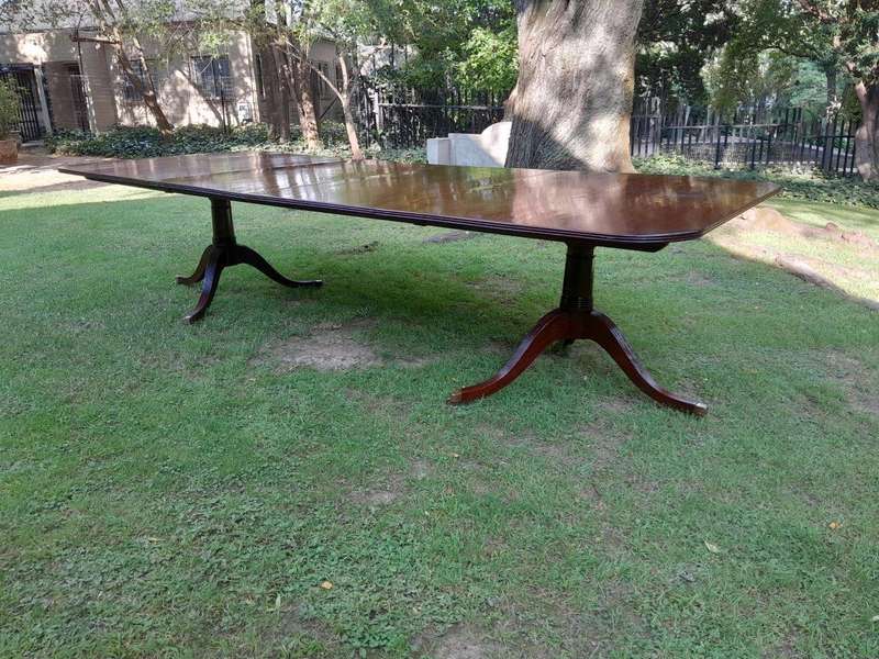A 20th Century Regency-style Mahogany Extending Dining Table On Casters with Two Leaves and One O...