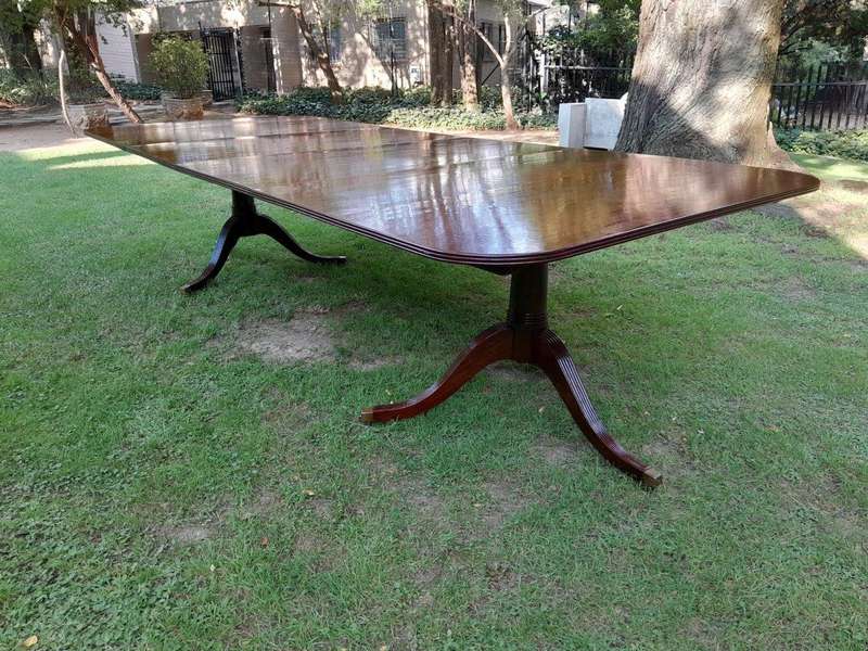 A 20th Century Regency-style Mahogany Extending Dining Table On Casters with Two Leaves and One O...