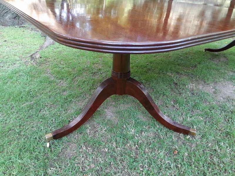 A 20th Century Regency-style Mahogany Extending Dining Table On Casters with Two Leaves and One O...