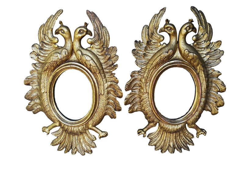 A 20th Century Pair Of Carved Mirrors With Stylised Bird Design