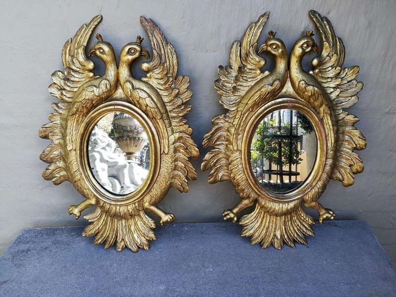 A 20th Century Pair Of Carved Mirrors With Stylised Bird Design