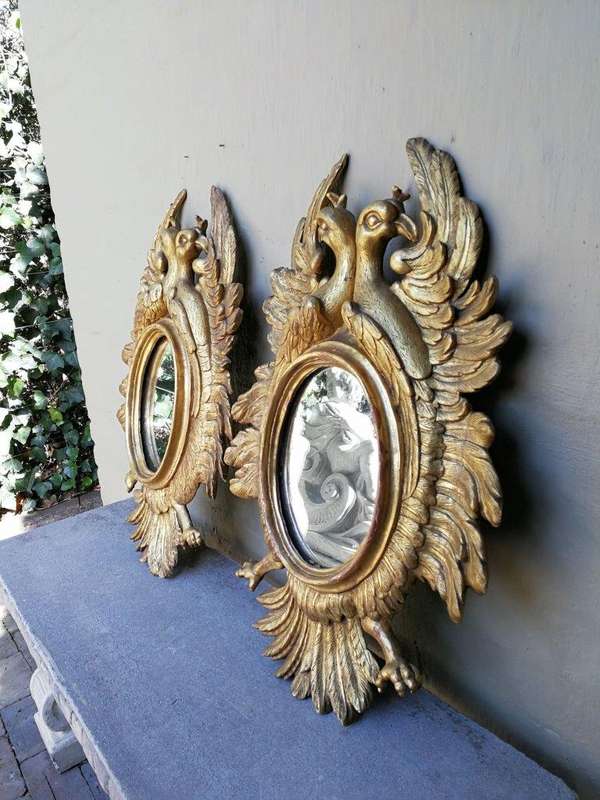 A 20th Century Pair Of Carved Mirrors With Stylised Bird Design