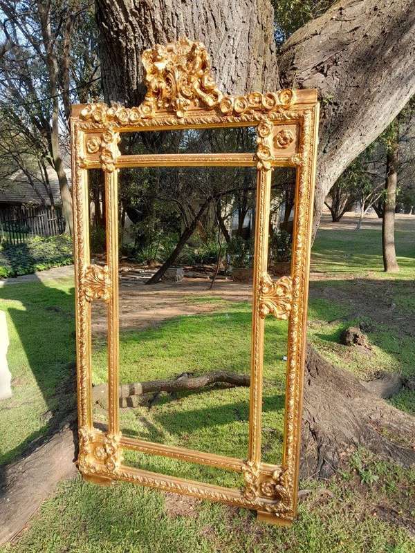 A French Style Ornately Carved and Gilded Bevelled Mirror