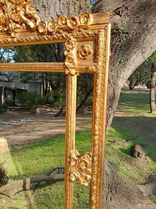 A French Style Ornately Carved and Gilded Bevelled Mirror