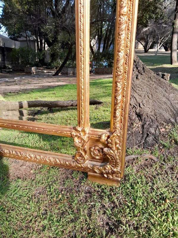 A French Style Ornately Carved and Gilded Bevelled Mirror