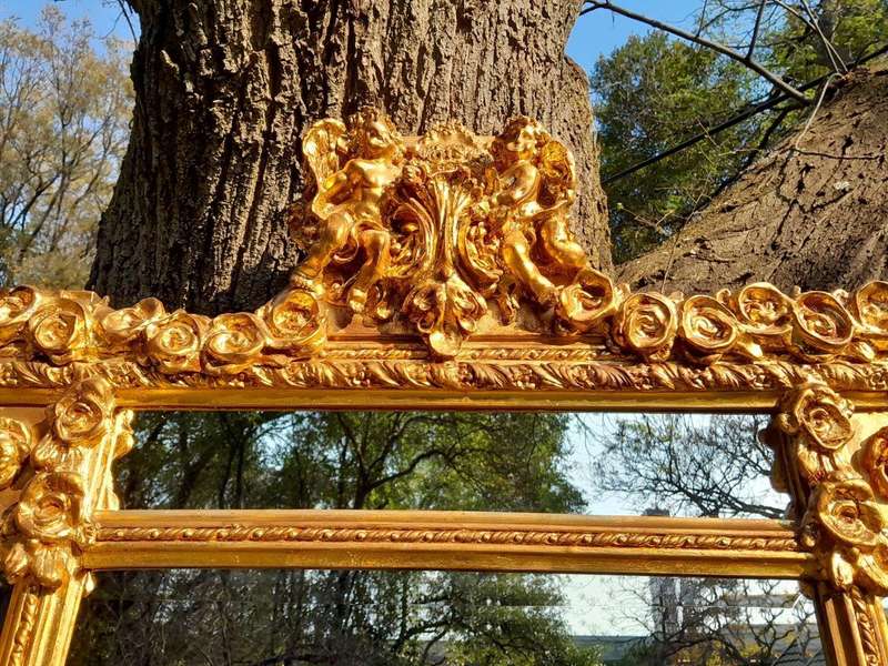 A French Style Ornately Carved and Gilded Bevelled Mirror