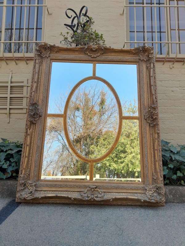 A Large and Heavily Carved Giltwood Bevelled Mirror