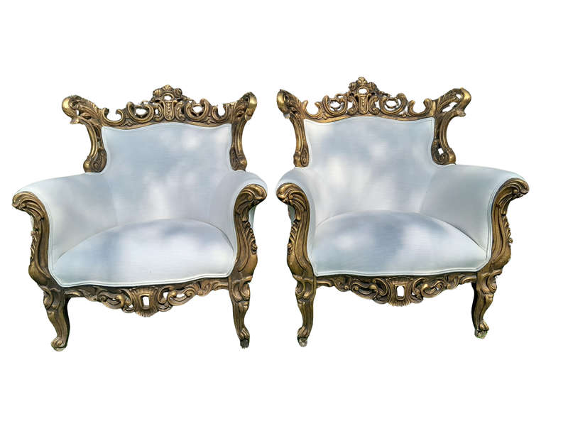 A French Style Pair of Ornately Carved Gilt Wood Armchairs