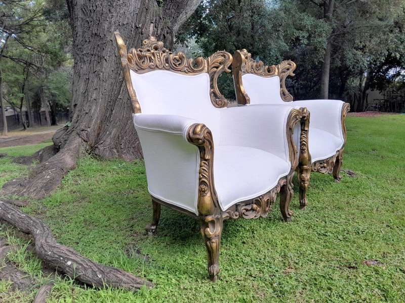 A French Style Pair of Ornately Carved Gilt Wood Armchairs