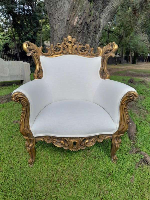 A French Style Pair of Ornately Carved Gilt Wood Armchairs