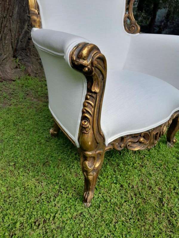 A French Style Pair of Ornately Carved Gilt Wood Armchairs