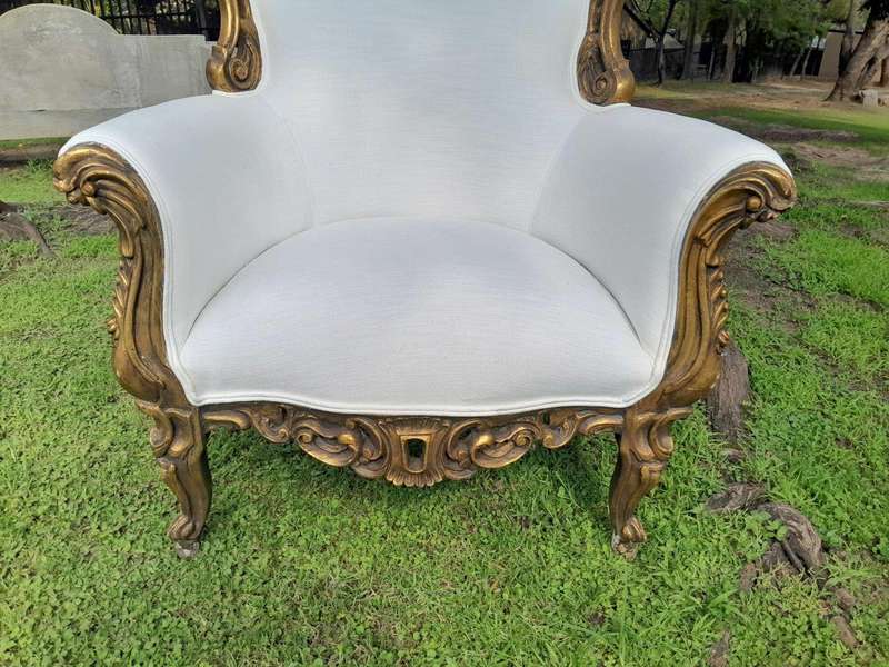 A French Style Pair of Ornately Carved Gilt Wood Armchairs