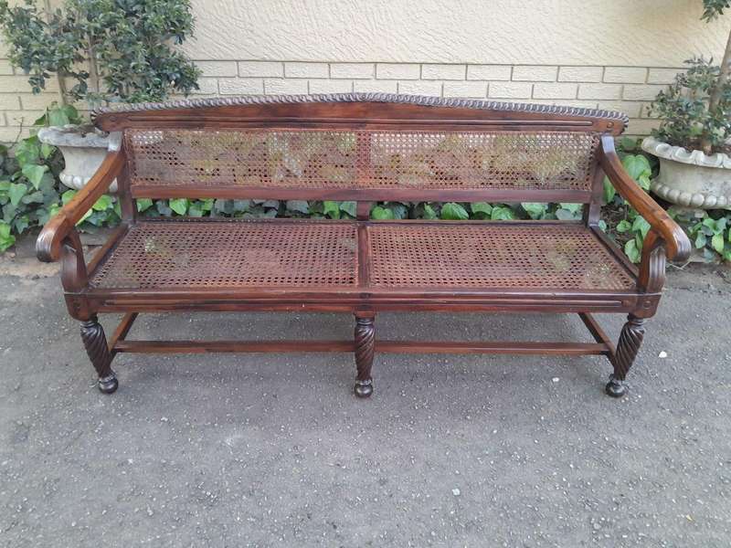 An Early 19th Century Rosewood Colonial Carved Bench with New Rattan in an Ebonised Finish