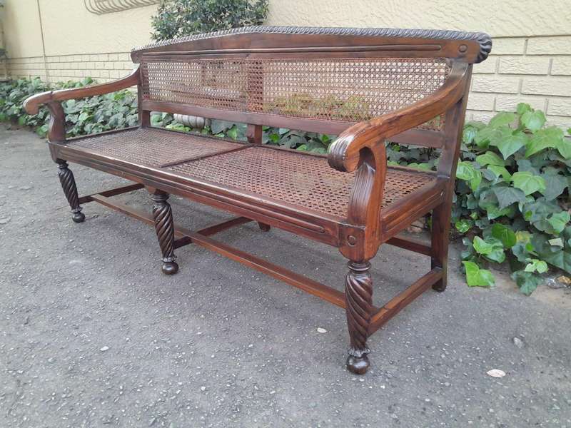 An Early 19th Century Rosewood Colonial Carved Bench with New Rattan in an Ebonised Finish