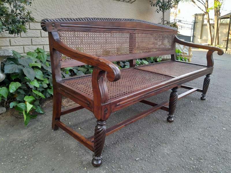 An Early 19th Century Rosewood Colonial Carved Bench with New Rattan in an Ebonised Finish
