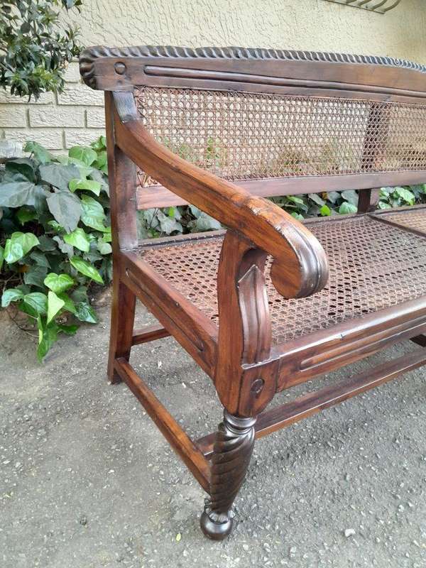 An Early 19th Century Rosewood Colonial Carved Bench with New Rattan in an Ebonised Finish