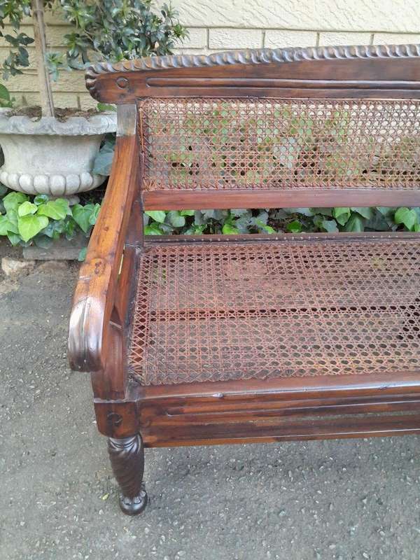 An Early 19th Century Rosewood Colonial Carved Bench with New Rattan in an Ebonised Finish