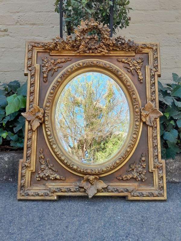 A 20th Century French Style Ornately Carved and Gilded Bevelled Mirror