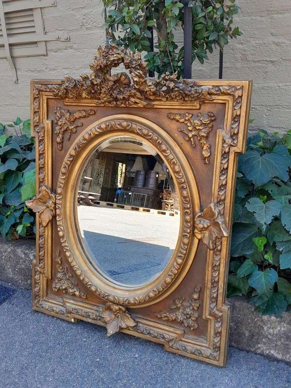 A 20th Century French Style Ornately Carved and Gilded Bevelled Mirror