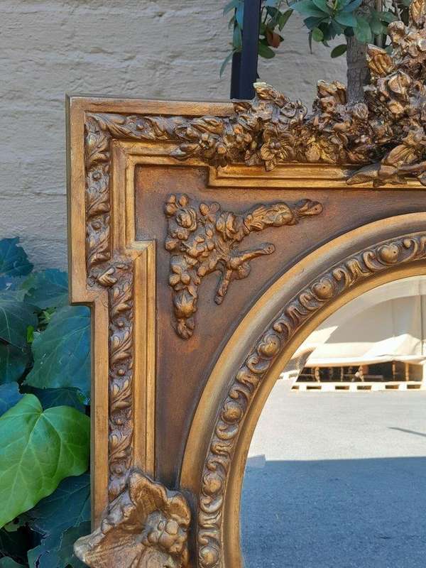A 20th Century French Style Ornately Carved and Gilded Bevelled Mirror