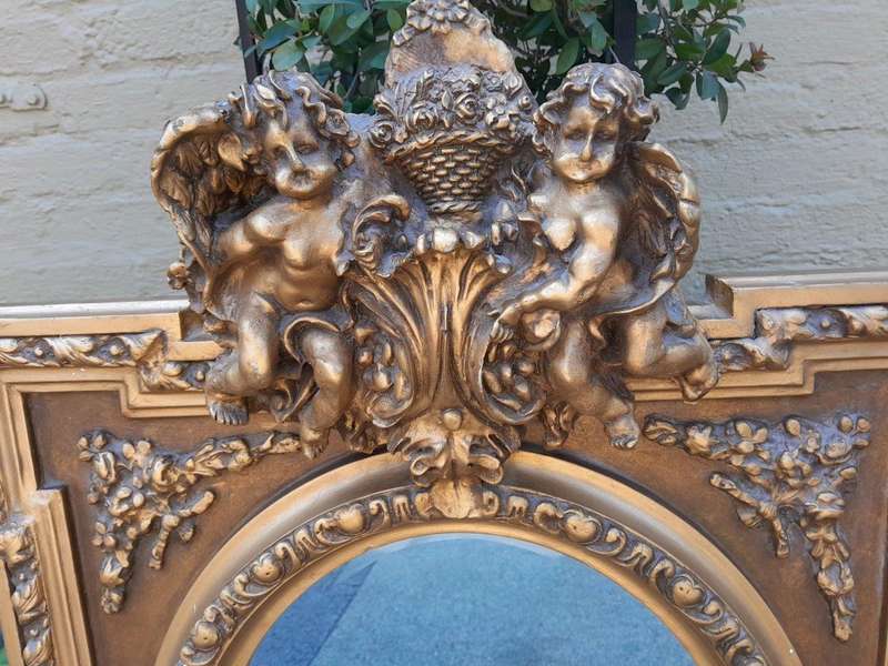An Exceptional Pair of 20th Century French Style Ornately Carved and Gilded Bevelled Mirrors with...