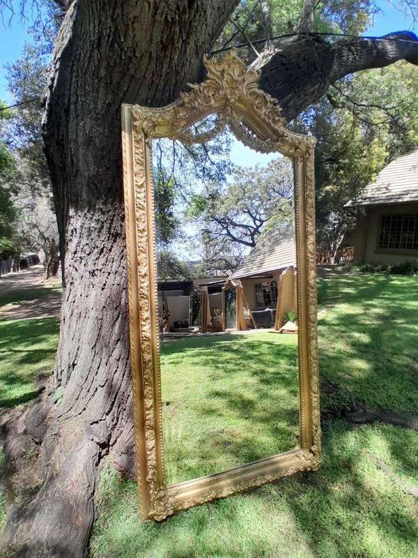 A French Rococo Style Ornately Carved and Gilded Bevelled Mirror
