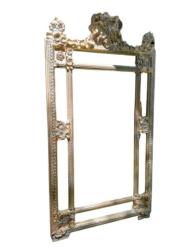 A French Rococo Style Ornately Carved and Gilded Bevelled Mirror