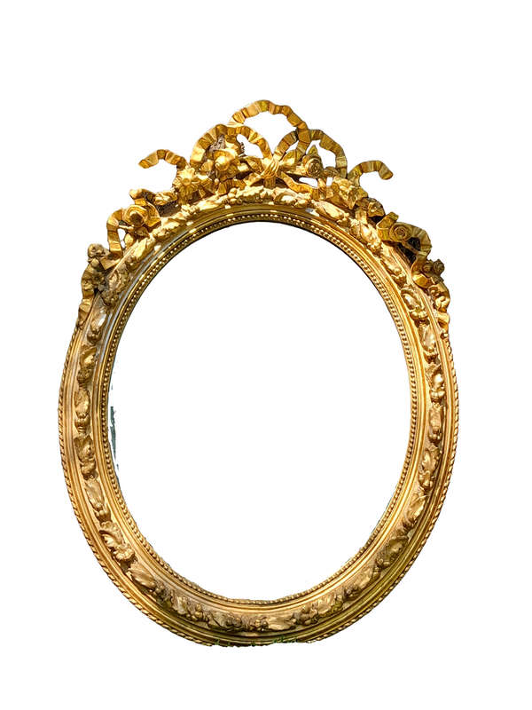 A French Rococo Style Ornately Carved and Gilded Oval Bevelled Mirror