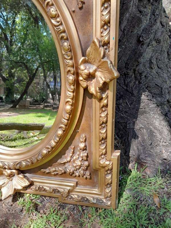 A 20th Century French Style Ornately Carved and Gilded Bevelled Mirror