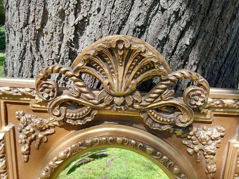 A 20th Century French Style Ornately Carved and Gilded Bevelled Mirror