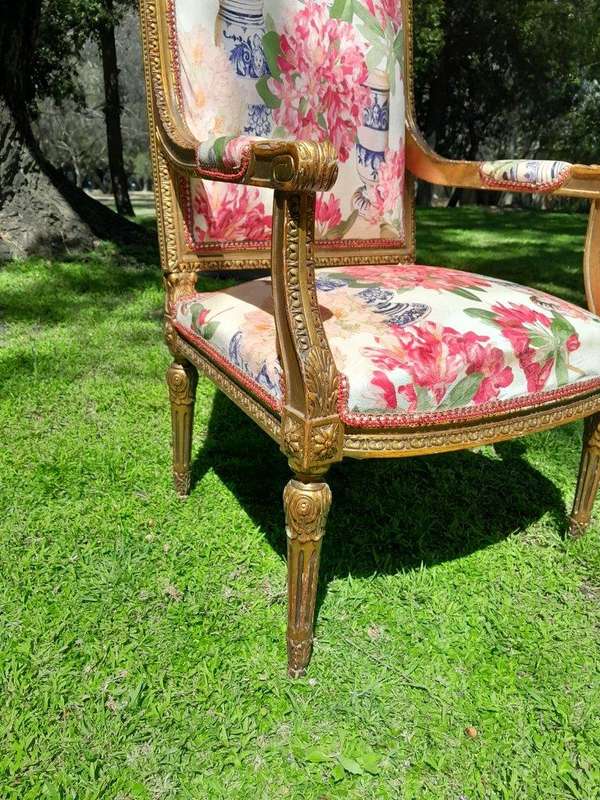 A Pair of 20th Century French Louis XVI Styled Ornately Carved and Gilded Fautelli Chairs