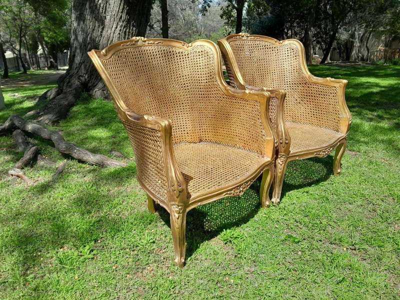 A 20th Century Pair of French Style Rattan Hand Gilded Wing Back Chairs
