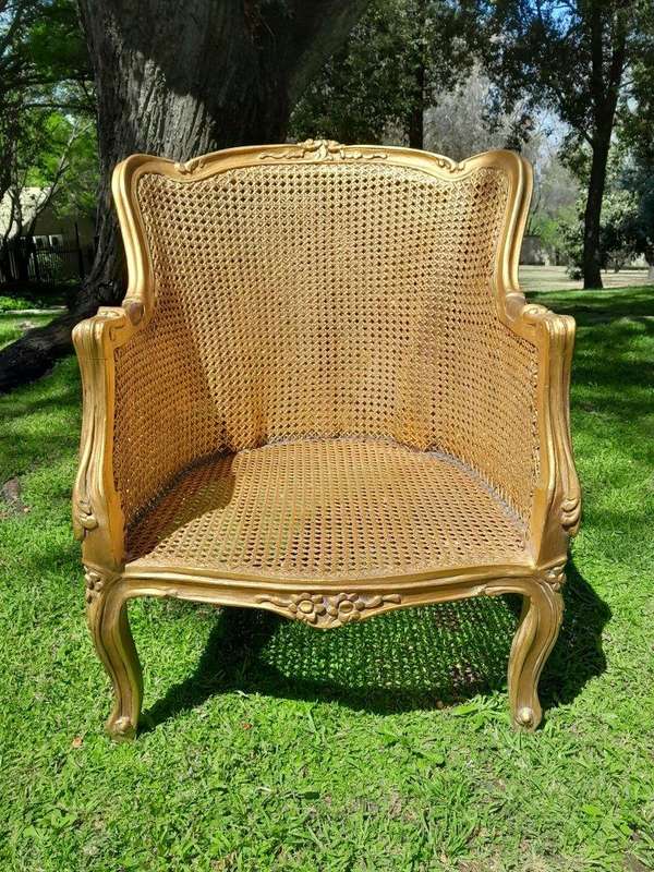 A 20th Century Pair of French Style Rattan Hand Gilded Wing Back Chairs