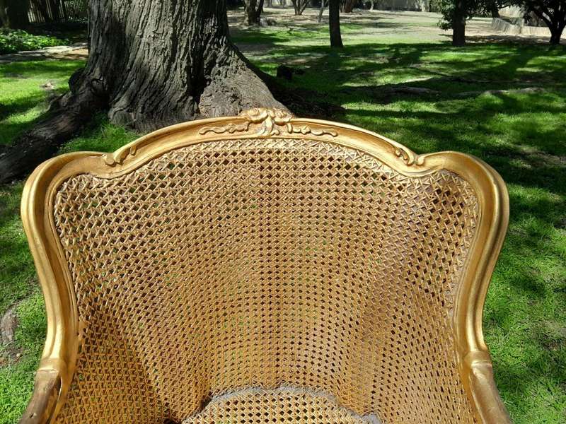 A 20th Century Pair of French Style Rattan Hand Gilded Wing Back Chairs