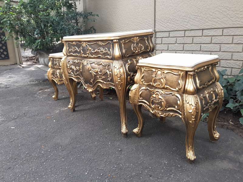 A Set of French Rococo Style Ornately Carved and Gilded Chest of Drawers and Pair of Side Tables ...