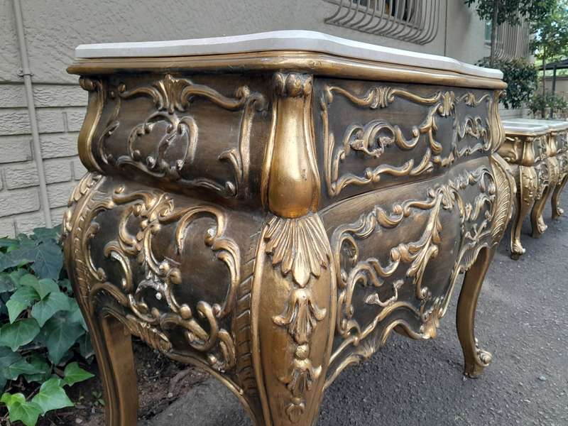 A Set of French Rococo Style Ornately Carved and Gilded Chest of Drawers and Pair of Side Tables ...