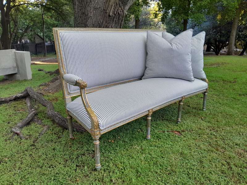 A 20th Century French  Style Carved and Hand Gilded Settee Upholstered in Ticking Fabric