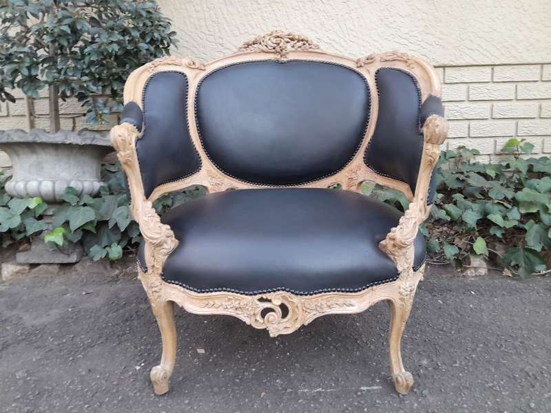 A 20TH Century French Style Bergere Style Carved Chair in a Contemporary Natural Wood Finish upho...