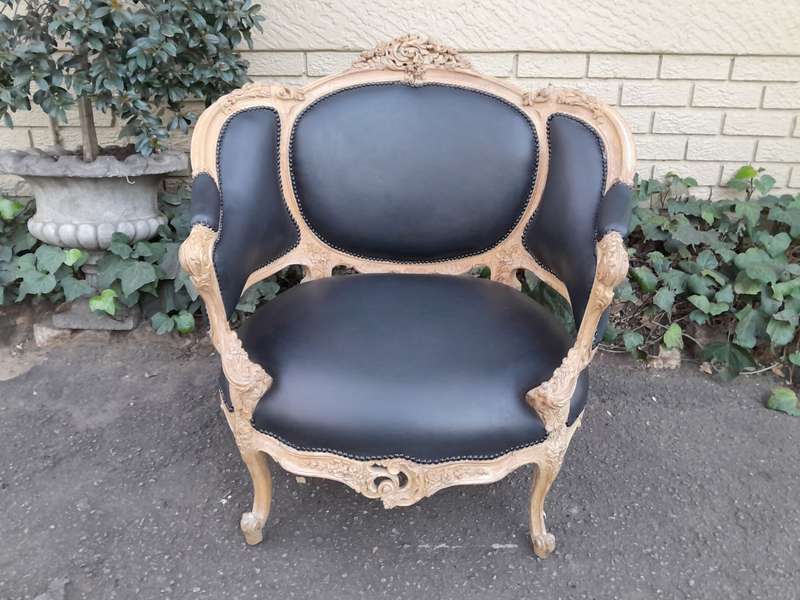 A 20TH Century French Style Bergere Style Carved Chair in a Contemporary Natural Wood Finish upho...