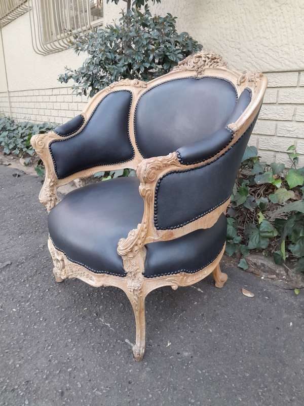 A 20TH Century French Style Bergere Style Carved Chair in a Contemporary Natural Wood Finish upho...