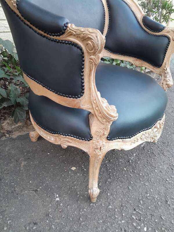 A 20TH Century French Style Bergere Style Carved Chair in a Contemporary Natural Wood Finish upho...