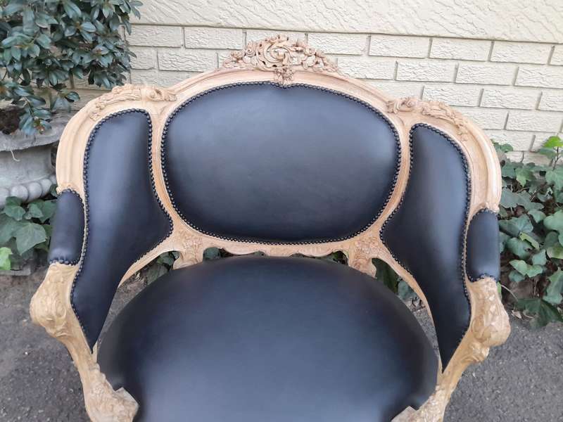 A 20TH Century French Style Bergere Style Carved Chair in a Contemporary Natural Wood Finish upho...