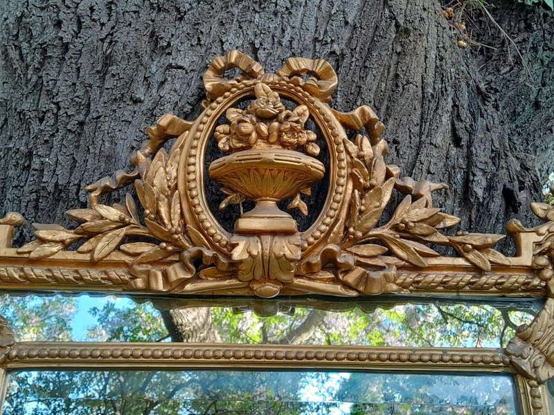 A French Rococo Style Ornately Carved and Gilded Bevelled Mirror
