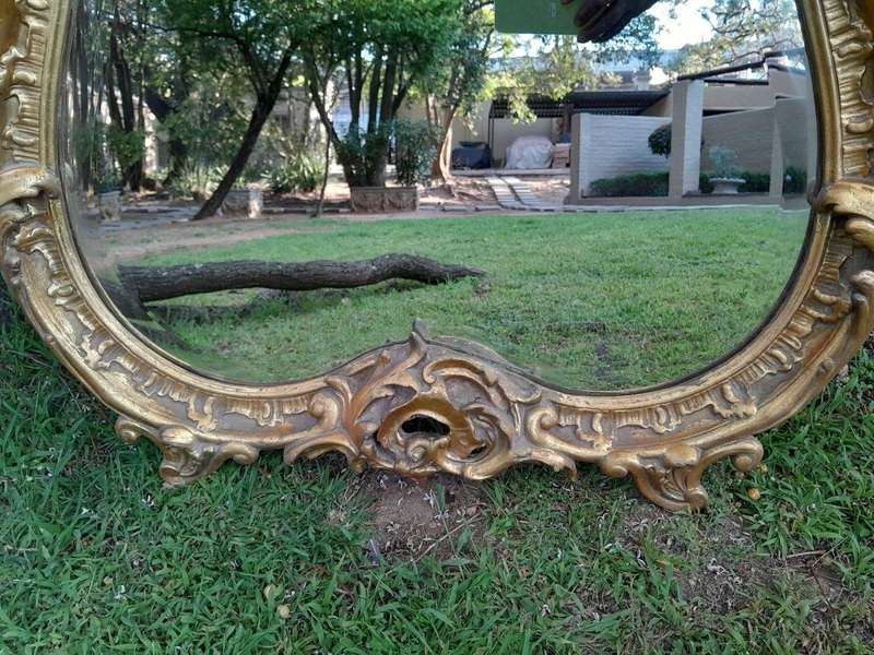 A French Rococo Style Ornately Carved and Gilded Bevelled Mirror