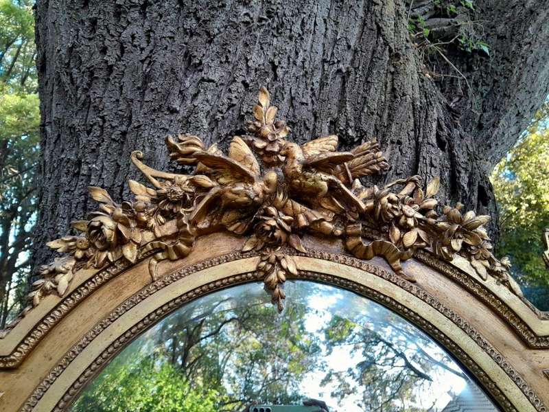 A French Rococo Style Ornately Carved and Gilded Bevelled Mirror