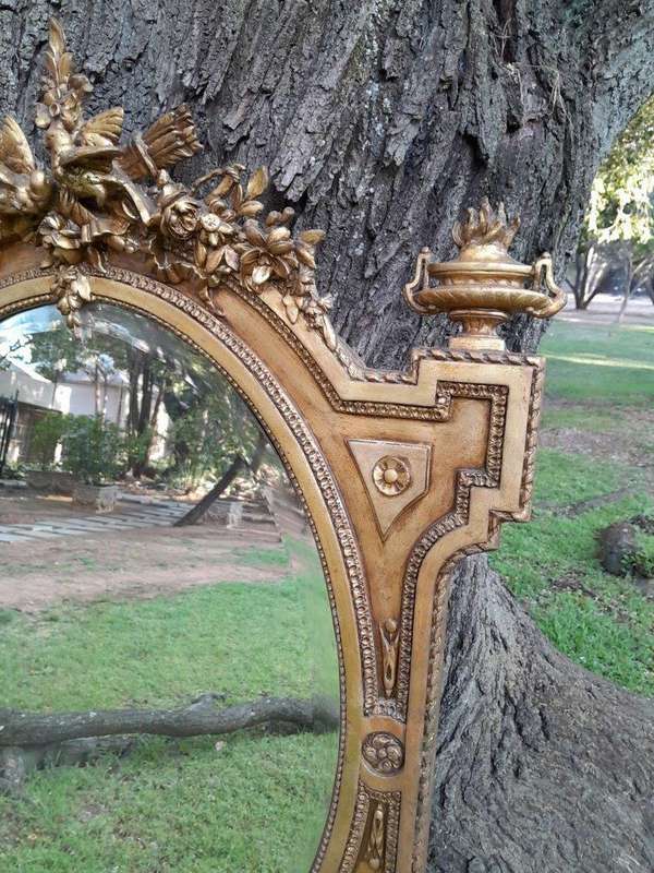 A French Rococo Style Ornately Carved and Gilded Bevelled Mirror