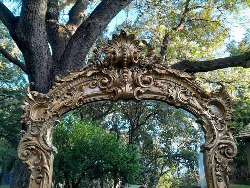A French Rococo Style Ornately Carved and Gilded Bevelled Mirror