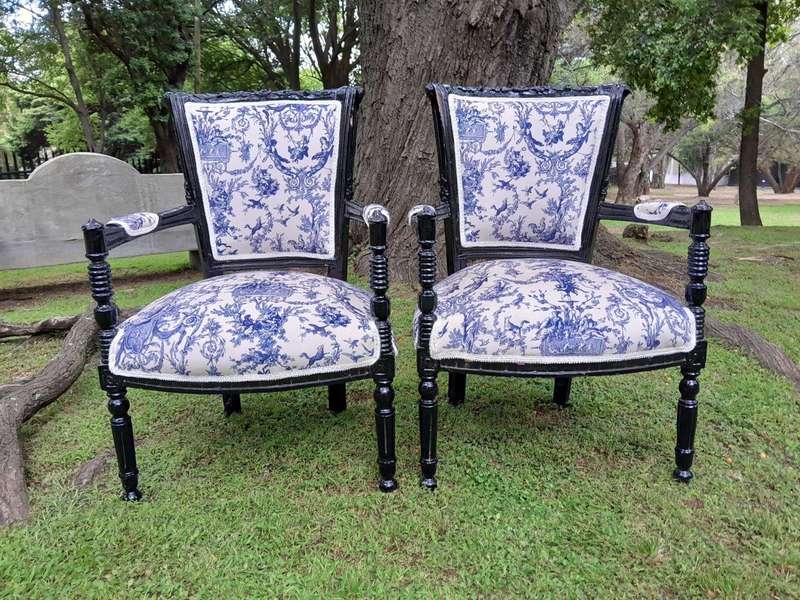 A Pair Of 20th Century French Louis XVI Styled Ornately Carved And Gilded Arm Chairs